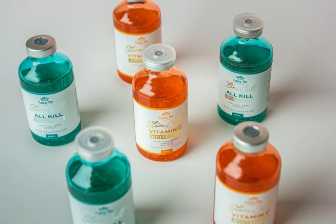 a group of six bottles of orange and blue liquid